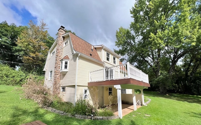 back of house with a yard and a deck