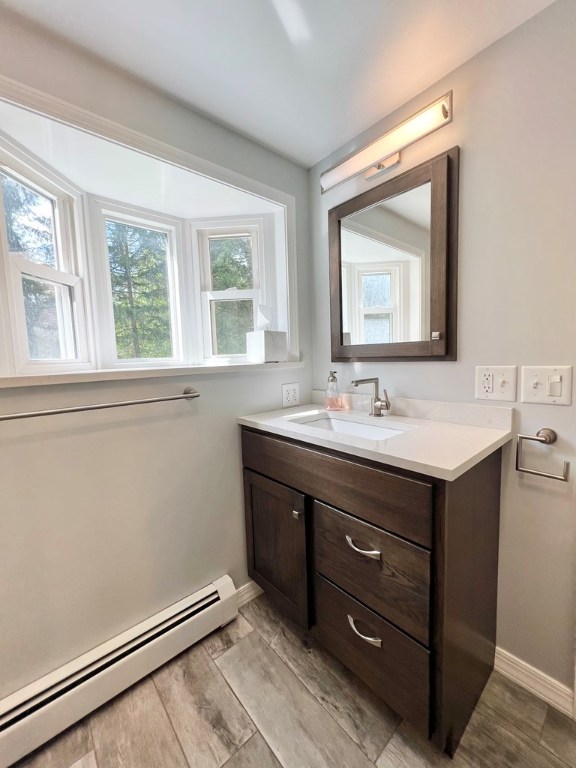 bathroom with vanity and baseboard heating