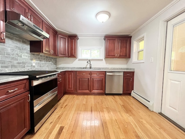 kitchen with sink, crown molding, stainless steel appliances, light hardwood / wood-style floors, and a baseboard radiator