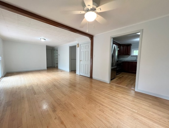 unfurnished room with ceiling fan, ornamental molding, and light hardwood / wood-style floors