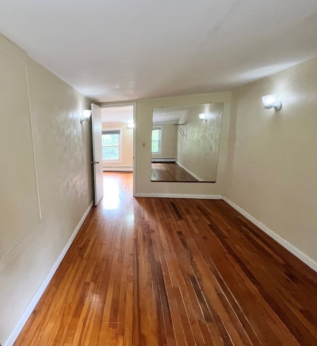 spare room with hardwood / wood-style floors and baseboard heating