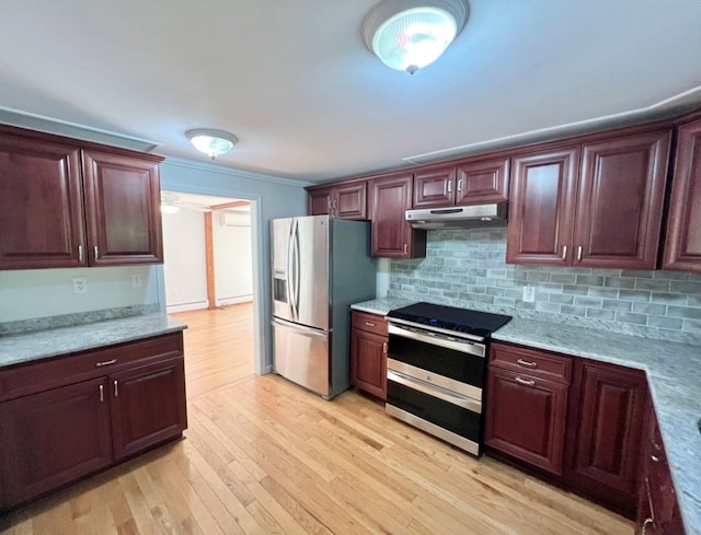 kitchen with appliances with stainless steel finishes, light stone countertops, light hardwood / wood-style floors, and decorative backsplash