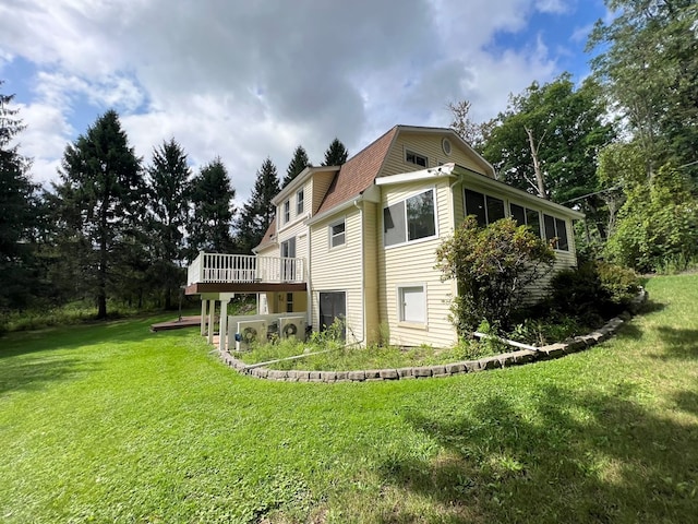 back of house with a yard and a deck