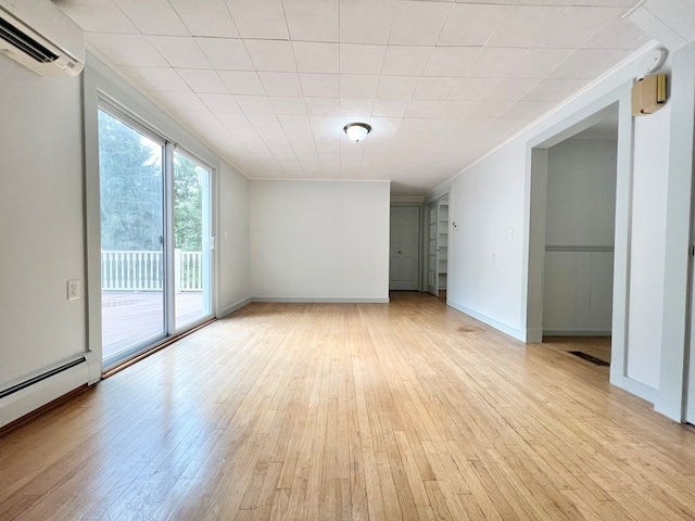 unfurnished room with a wall mounted air conditioner, crown molding, light hardwood / wood-style flooring, and a baseboard heating unit