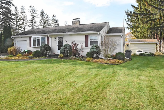 single story home with a garage and a front lawn