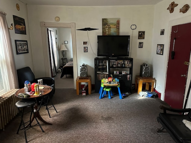 recreation room featuring radiator and carpet flooring