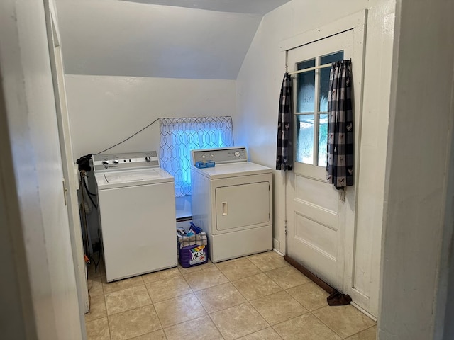 clothes washing area with light tile patterned floors and independent washer and dryer