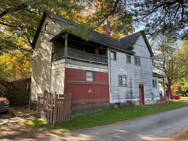 view of side of home featuring a balcony