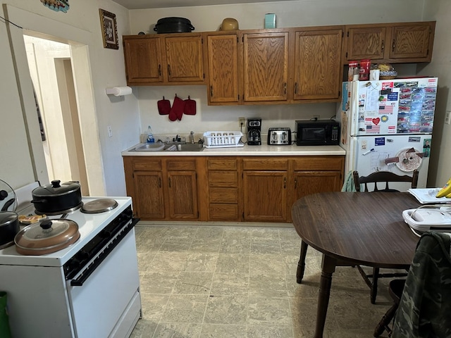 kitchen featuring sink and white appliances