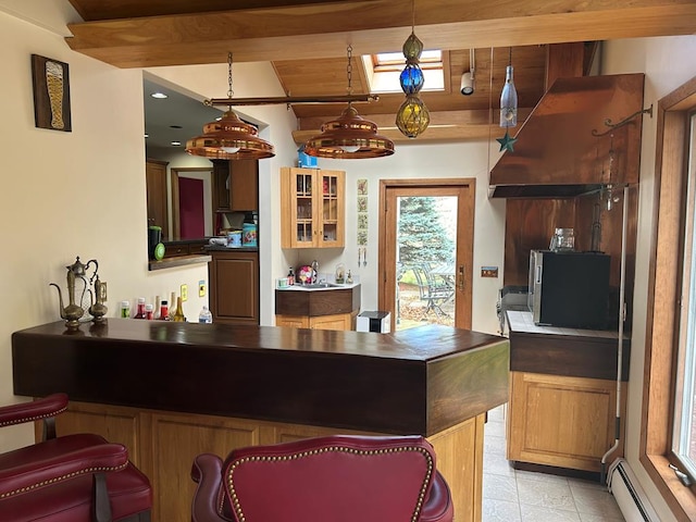 kitchen with a baseboard radiator, decorative light fixtures, and light tile patterned floors