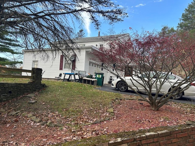 rear view of property with a garage