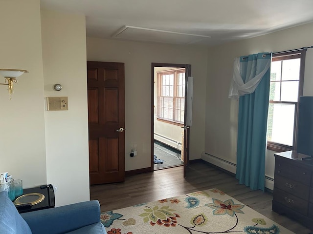 interior space featuring dark hardwood / wood-style flooring and a baseboard heating unit