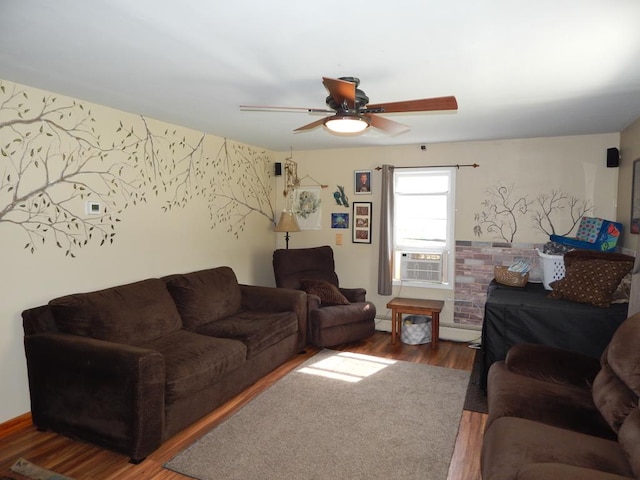 living room with cooling unit, wood-type flooring, and ceiling fan