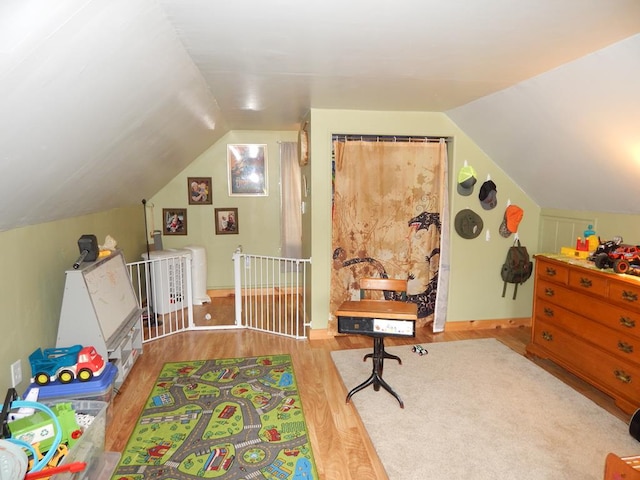 recreation room with lofted ceiling and light hardwood / wood-style flooring