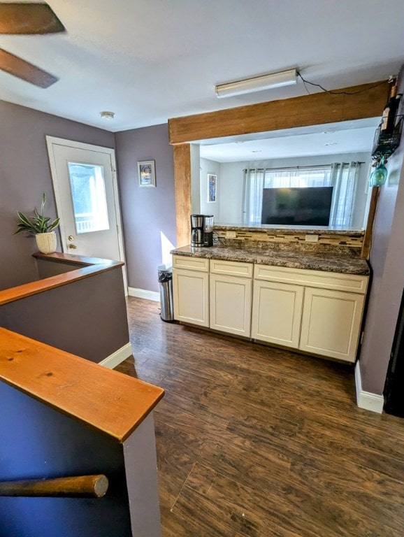 kitchen featuring dark hardwood / wood-style flooring and white cabinets