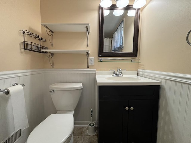 bathroom featuring tile patterned floors, vanity, and toilet