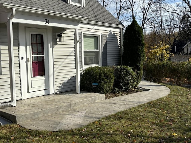 doorway to property featuring a yard