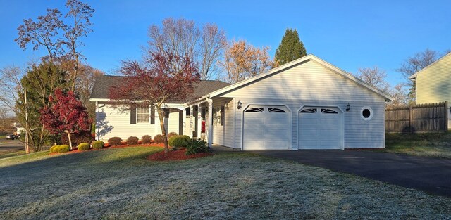 single story home featuring a garage and a front yard