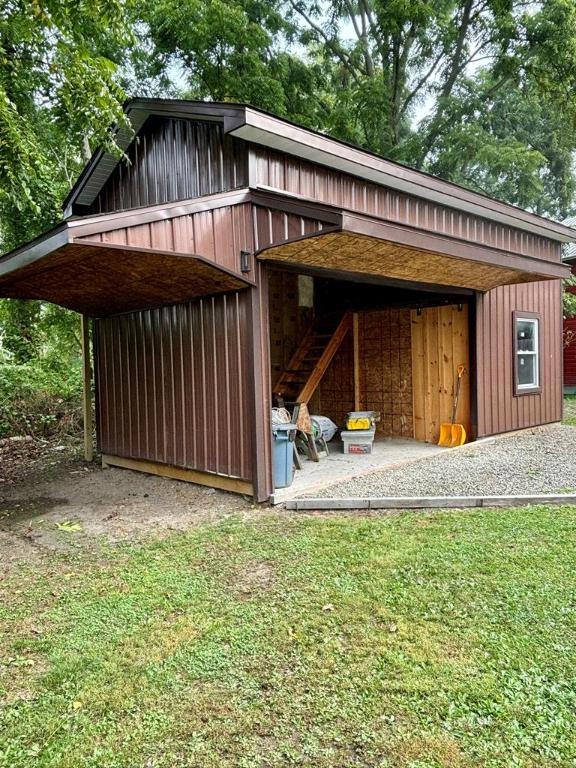 view of outbuilding with a lawn