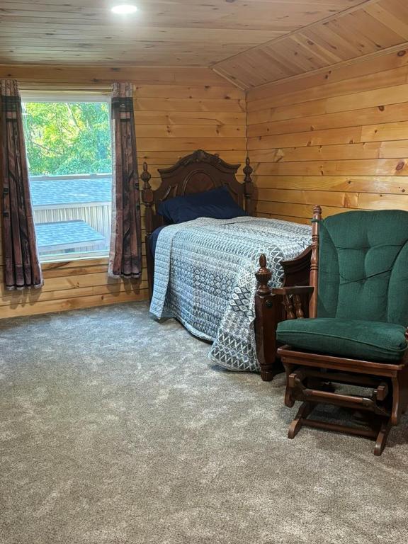 bedroom featuring carpet floors, vaulted ceiling, wooden walls, and wood ceiling