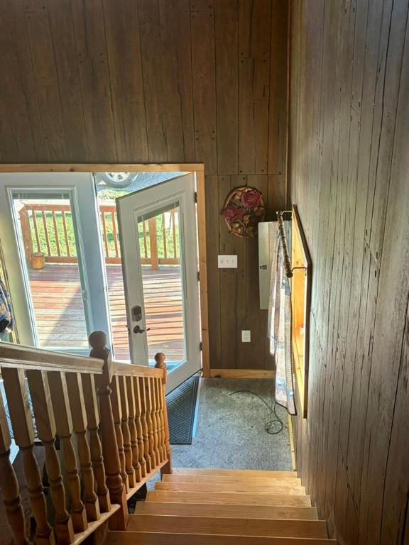 entryway with wood walls