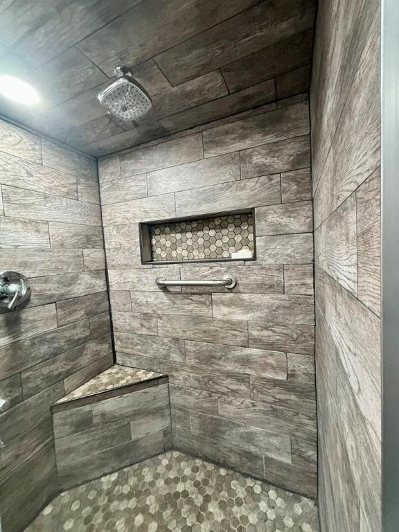 bathroom with a tile shower