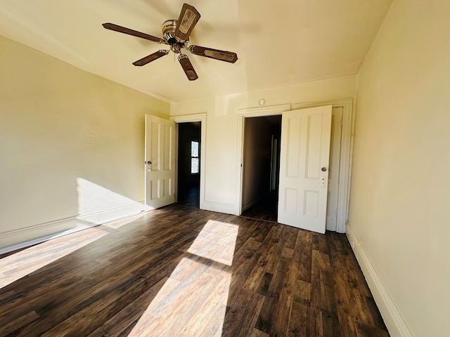 unfurnished bedroom with ceiling fan and dark hardwood / wood-style floors