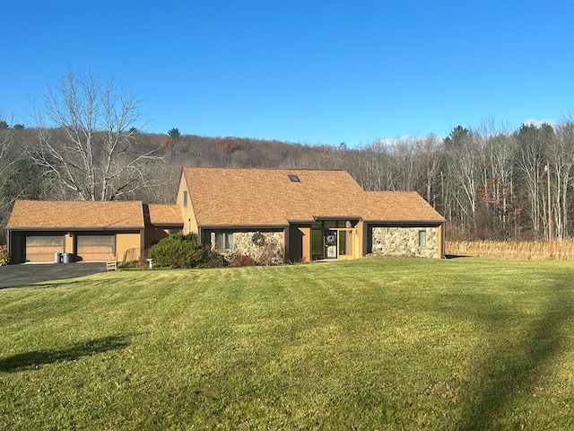 view of front of property with a garage and a front lawn