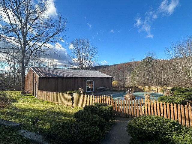 exterior space with a yard and an outdoor structure