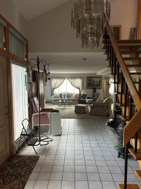 living room with lofted ceiling and light tile patterned floors