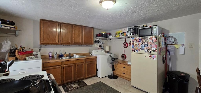 kitchen with washer / clothes dryer, range with electric stovetop, sink, and white refrigerator