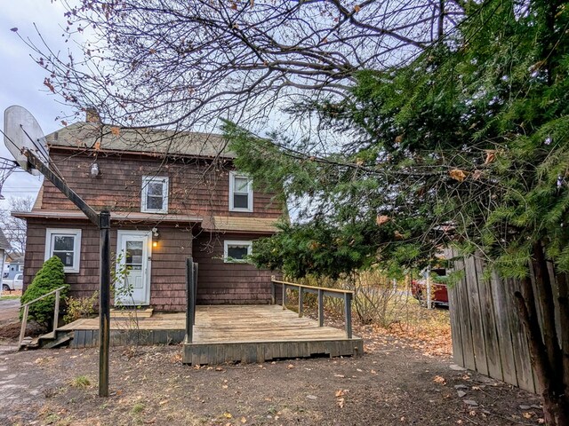 rear view of house featuring a wooden deck