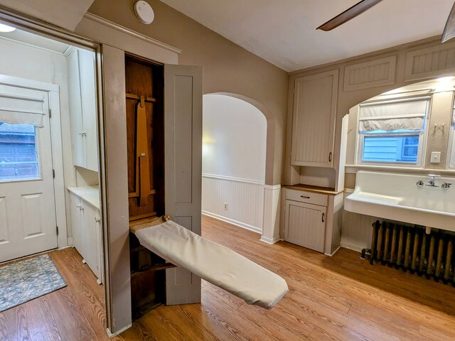 interior space with wood-type flooring and ceiling fan