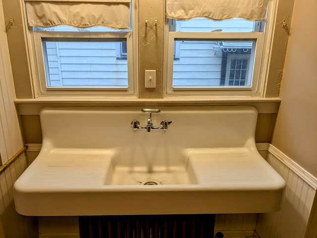 bathroom featuring a sink and wainscoting