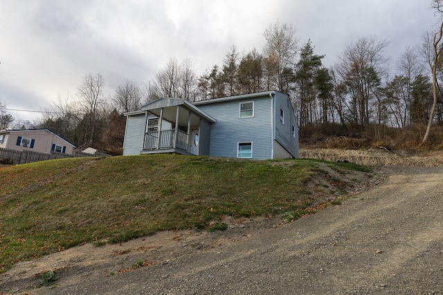 view of front of home with a front yard and covered porch