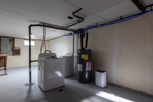 basement featuring washer and dryer, electric panel, and electric water heater