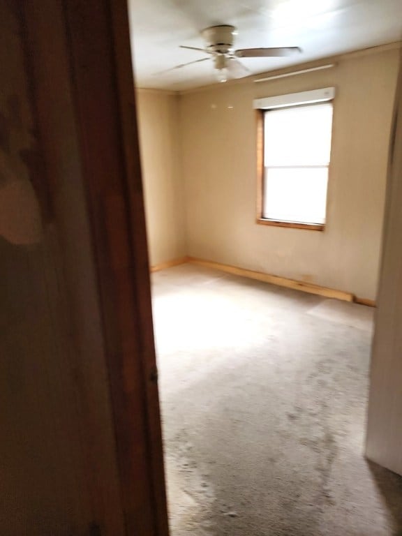 carpeted empty room with ceiling fan