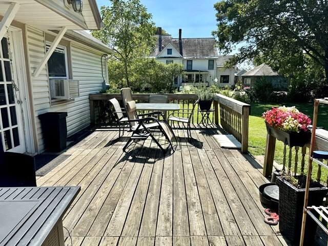 wooden deck featuring cooling unit