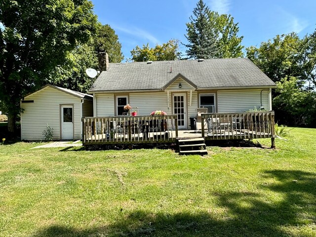 back of house featuring a wooden deck and a yard