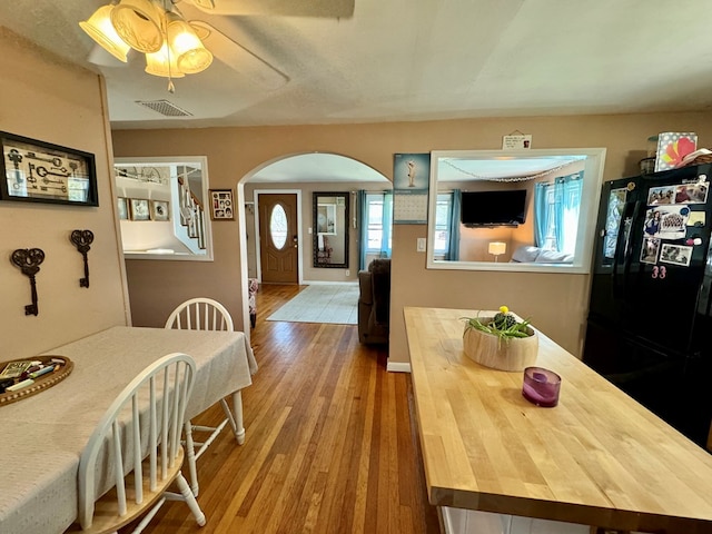 dining space featuring hardwood / wood-style flooring and ceiling fan