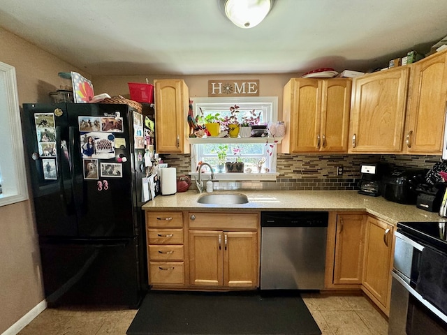 kitchen with sink, tasteful backsplash, black refrigerator, stainless steel dishwasher, and double oven range