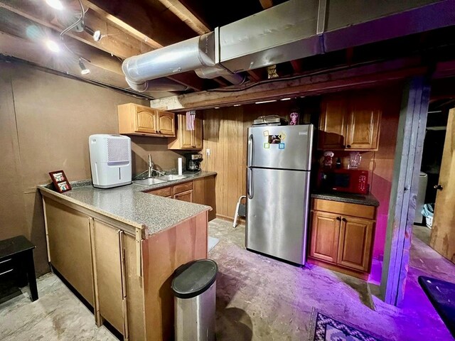 kitchen featuring sink and stainless steel refrigerator