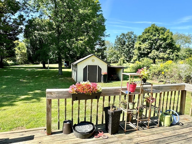 wooden terrace with a storage shed and a lawn