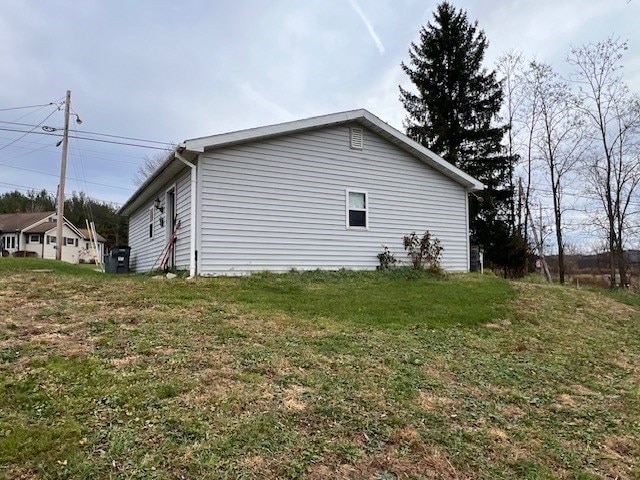 view of property exterior featuring a yard