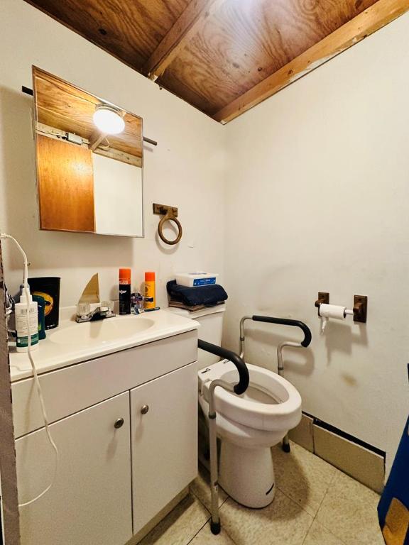 bathroom featuring vanity, toilet, tile patterned flooring, and wooden ceiling