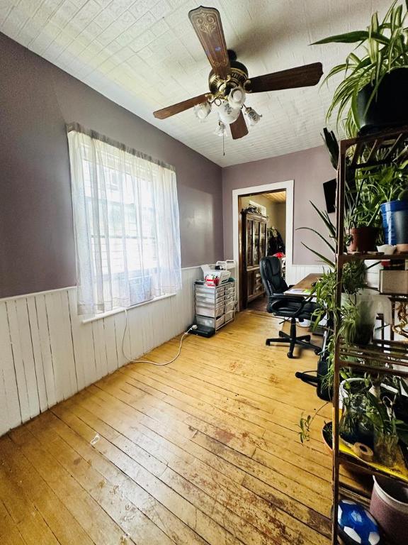 home office with ceiling fan and light hardwood / wood-style flooring