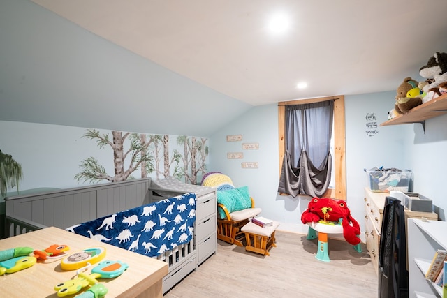 bedroom with vaulted ceiling and light wood-type flooring