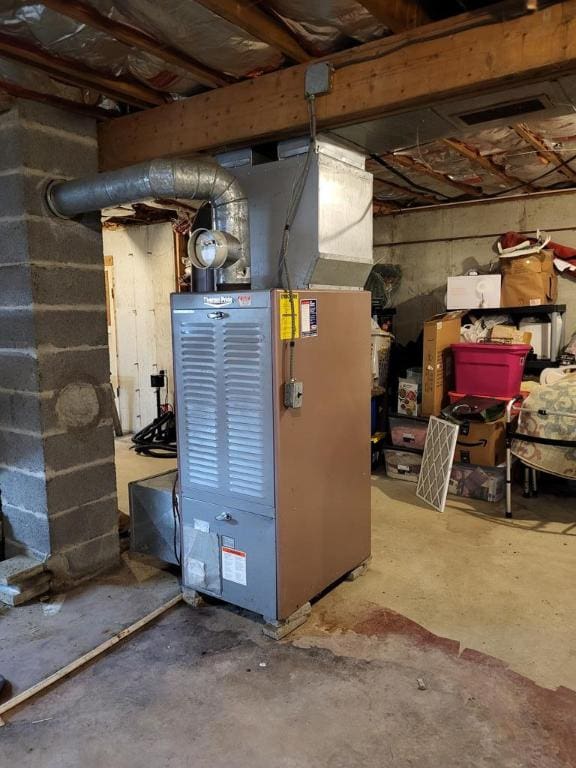 utility room featuring heating unit