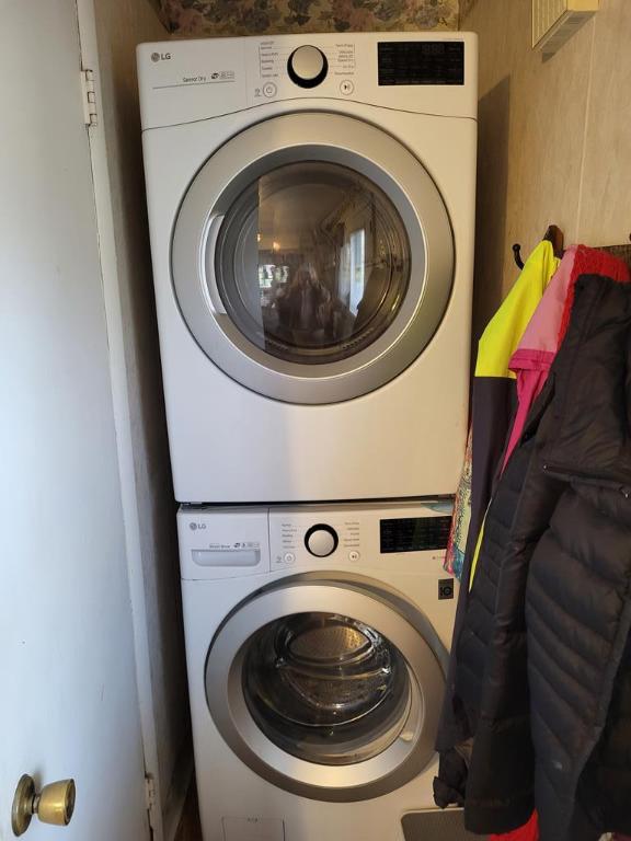 laundry area with stacked washer and clothes dryer