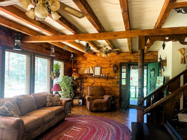 living room with beam ceiling, plenty of natural light, dark parquet floors, and ceiling fan